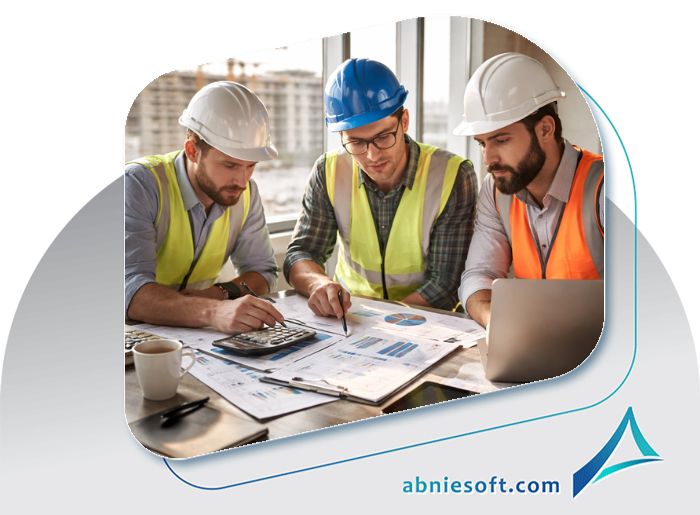 تصویری از سه مهندس که درحال کار در محیط کاری و مدیریت مالی پیمانکاری ساختمان هستند.